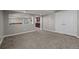Finished basement with carpet, access to the wet bar, and double doors to an unfinished area at 13322 Meadow Park Ln, Broomfield, CO 80020