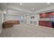 Finished basement space with carpeting, built-in shelving, and a wet bar area, perfect for entertaining at 13322 Meadow Park Ln, Broomfield, CO 80020