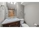 Neutral-toned bathroom featuring a granite countertop, decorative camel, and tiled shower at 13322 Meadow Park Ln, Broomfield, CO 80020