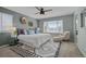 Serene bedroom featuring a plush bed, decorative wall art, and a cozy sitting area near the window at 13322 Meadow Park Ln, Broomfield, CO 80020