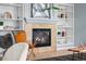 Close-up of a cozy fireplace with a stone surround, built-in shelving, and stylish decor at 13322 Meadow Park Ln, Broomfield, CO 80020