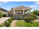 Charming home with a covered front porch, stone accents, and a well-manicured front yard at 13322 Meadow Park Ln, Broomfield, CO 80020