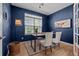 Charming home office with hardwood floors, natural light, stylish decor and blue accent wall at 13322 Meadow Park Ln, Broomfield, CO 80020