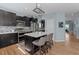 Modern kitchen features black cabinets, stainless steel appliances, and a kitchen island with seating at 13322 Meadow Park Ln, Broomfield, CO 80020