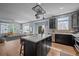 Spacious kitchen with an island connected to a living room with lots of light at 13322 Meadow Park Ln, Broomfield, CO 80020