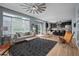 Bright living room featuring large windows, modern decor, and an open layout connecting to the kitchen at 13322 Meadow Park Ln, Broomfield, CO 80020