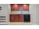 Wet bar featuring granite countertops, dark cabinets, and modern appliances at 13322 Meadow Park Ln, Broomfield, CO 80020