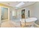 Bright bathroom with a free standing tub, glass enclosed shower, and a skylight for natural light at 2552 E Alameda Ave # 74, Denver, CO 80209