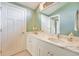 Bright bathroom with white marble countertop and sink, complimented by light green walls at 2552 E Alameda Ave # 74, Denver, CO 80209