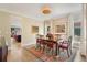 Formal dining room featuring a hardwood floors, classic furniture, and elegant light fixture at 2552 E Alameda Ave # 74, Denver, CO 80209