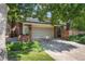 Charming single-Gathering home showcasing a well-manicured lawn, mature trees, and a convenient two-car garage at 2552 E Alameda Ave # 74, Denver, CO 80209