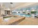Indoor pool and hot tub area with natural light and accessibility features in community center at 2552 E Alameda Ave # 74, Denver, CO 80209