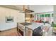 Spacious kitchen island with a gas cooktop and a view of the sliding doors to a brick patio at 2552 E Alameda Ave # 74, Denver, CO 80209