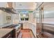 Bright kitchen featuring white cabinetry, marble countertops, and stainless steel appliances at 2552 E Alameda Ave # 74, Denver, CO 80209