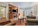 Open-concept living room with built-in shelving, bay windows and elegant fireplace feature at 2552 E Alameda Ave # 74, Denver, CO 80209