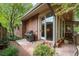 Outdoor patio area featuring a barbecue, landscaping, and access to the sunroom at 2552 E Alameda Ave # 74, Denver, CO 80209