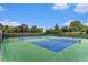 Community tennis courts surrounded by mature trees and lush landscaping at 2552 E Alameda Ave # 74, Denver, CO 80209