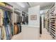 Organized walk-in closet with ample shelving, hanging space, and central island for storage at 2552 E Alameda Ave # 74, Denver, CO 80209