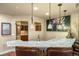 Wet bar with granite countertops, pendant lighting, seating and bar sink at 2317 Primo Rd # A, Highlands Ranch, CO 80129