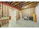 Unfinished basement featuring open design, exposed beams, and a utility sink with access to plumbing for future expansion at 2317 Primo Rd # A, Highlands Ranch, CO 80129