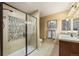 Modern bathroom with glass-enclosed shower, tiled walls, and a contemporary vanity offers a clean and stylish design at 2317 Primo Rd # A, Highlands Ranch, CO 80129