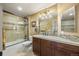 Nicely renovated bathroom featuring sleek vanity with granite countertop, stylish tile backsplash, and glass enclosed shower at 2317 Primo Rd # A, Highlands Ranch, CO 80129