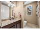 Charming powder room with granite counters and a framed mirror at 2317 Primo Rd # A, Highlands Ranch, CO 80129