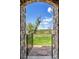 Stunning view through stone archway onto picturesque lawn with lake views at 2317 Primo Rd # A, Highlands Ranch, CO 80129