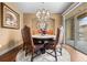 Elegant dining room with stylish chandelier, a round table and floor to ceiling window at 2317 Primo Rd # A, Highlands Ranch, CO 80129