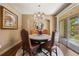 This dining room features an elegant chandelier and views to the exterior at 2317 Primo Rd # A, Highlands Ranch, CO 80129