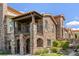 Beautiful multi-story stone home featuring a balcony and manicured landscaping at 2317 Primo Rd # A, Highlands Ranch, CO 80129