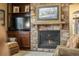 Close-up of living room's stone fireplace, built-ins, and hearth create a cozy, inviting atmosphere at 2317 Primo Rd # A, Highlands Ranch, CO 80129