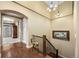 Entryway with hardwood floors, decorative chandelier, bronze deer statue, and view into an adjacent room at 2317 Primo Rd # A, Highlands Ranch, CO 80129