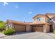 Attached garages with stylish brown doors and stone accents on a sunny day at 2317 Primo Rd # A, Highlands Ranch, CO 80129