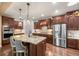 Gourmet kitchen featuring stainless appliances, granite counters, and hardwood floors at 2317 Primo Rd # A, Highlands Ranch, CO 80129