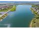 Scenic aerial view of a pristine lake surrounded by lush greenery and roadways at 2317 Primo Rd # A, Highlands Ranch, CO 80129