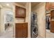 Laundry room with stacked washer and dryer, custom cabinets, and granite countertop at 2317 Primo Rd # A, Highlands Ranch, CO 80129