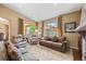 Cozy living room with large windows, plush seating, and elegant decor offers comfortable gathering space at 2317 Primo Rd # A, Highlands Ranch, CO 80129