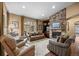 Cozy living room showcasing a stone fireplace and comfortable seating arrangement at 2317 Primo Rd # A, Highlands Ranch, CO 80129