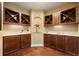 Elegant wine room with custom cabinetry, marble counters, and hardwood floors offers a sophisticated space for wine enthusiasts at 2317 Primo Rd # A, Highlands Ranch, CO 80129