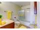 Well-lit bathroom featuring a shower with glass doors, ceramic tile flooring, and ample storage space at 9180 E Center Ave # 9D, Denver, CO 80247