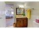 Modern bathroom features an expansive vanity, ample lighting, and easy access to the adjacent bedroom at 9180 E Center Ave # 9D, Denver, CO 80247
