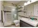 Bright bathroom featuring a glass-enclosed shower, modern vanity, and stylish tile accents at 9180 E Center Ave # 9D, Denver, CO 80247