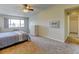 Comfortable bedroom featuring a ceiling fan, neutral walls, ample natural light, and easy access to hallway at 9180 E Center Ave # 9D, Denver, CO 80247