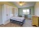 Cozy bedroom featuring a ceiling fan, neutral walls, built-in storage, and desk space for productivity at 9180 E Center Ave # 9D, Denver, CO 80247