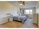Cozy bedroom features natural light, neutral walls, and an overhead fan for year-round comfort at 9180 E Center Ave # 9D, Denver, CO 80247