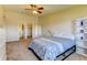 Spacious bedroom with en-suite bathroom, walk-in closet, overhead fan, and plenty of natural light at 9180 E Center Ave # 9D, Denver, CO 80247