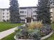 Attractive condominium building with landscaped flower bed in front of entry at 9180 E Center Ave # 9D, Denver, CO 80247
