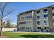 Exterior view of a multi-story apartment building featuring large windows and a well-maintained facade at 9180 E Center Ave # 9D, Denver, CO 80247