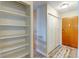 Hallway featuring closet space and entry door at 9180 E Center Ave # 9D, Denver, CO 80247